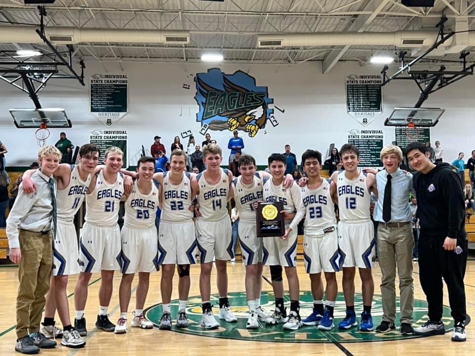 Boys Basketball Team holding an award