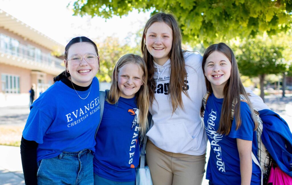 Four middle school girls standing together outside