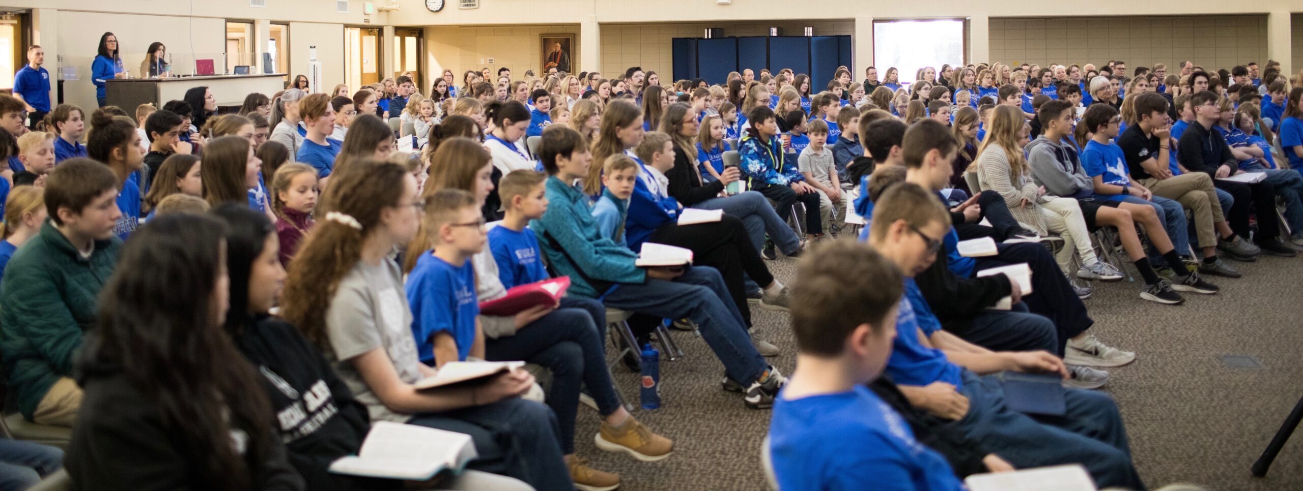 Large group photo of students at a chapel service