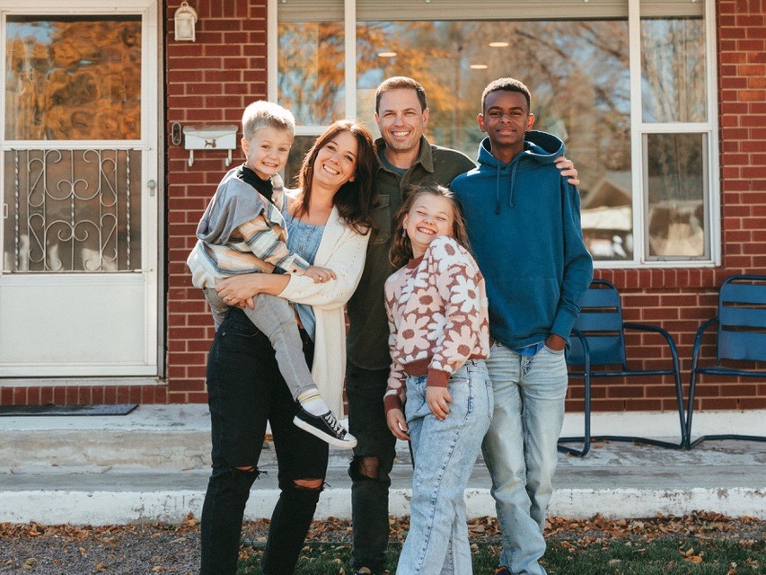 Family of five standing together outdoors