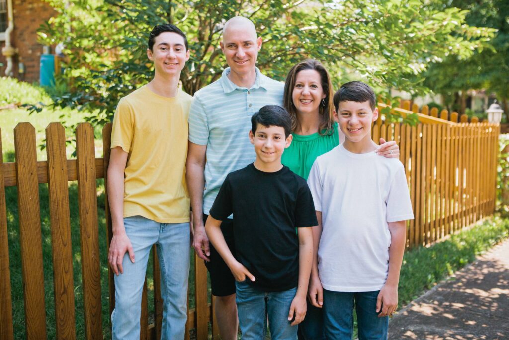 Family of five standing together outdoors