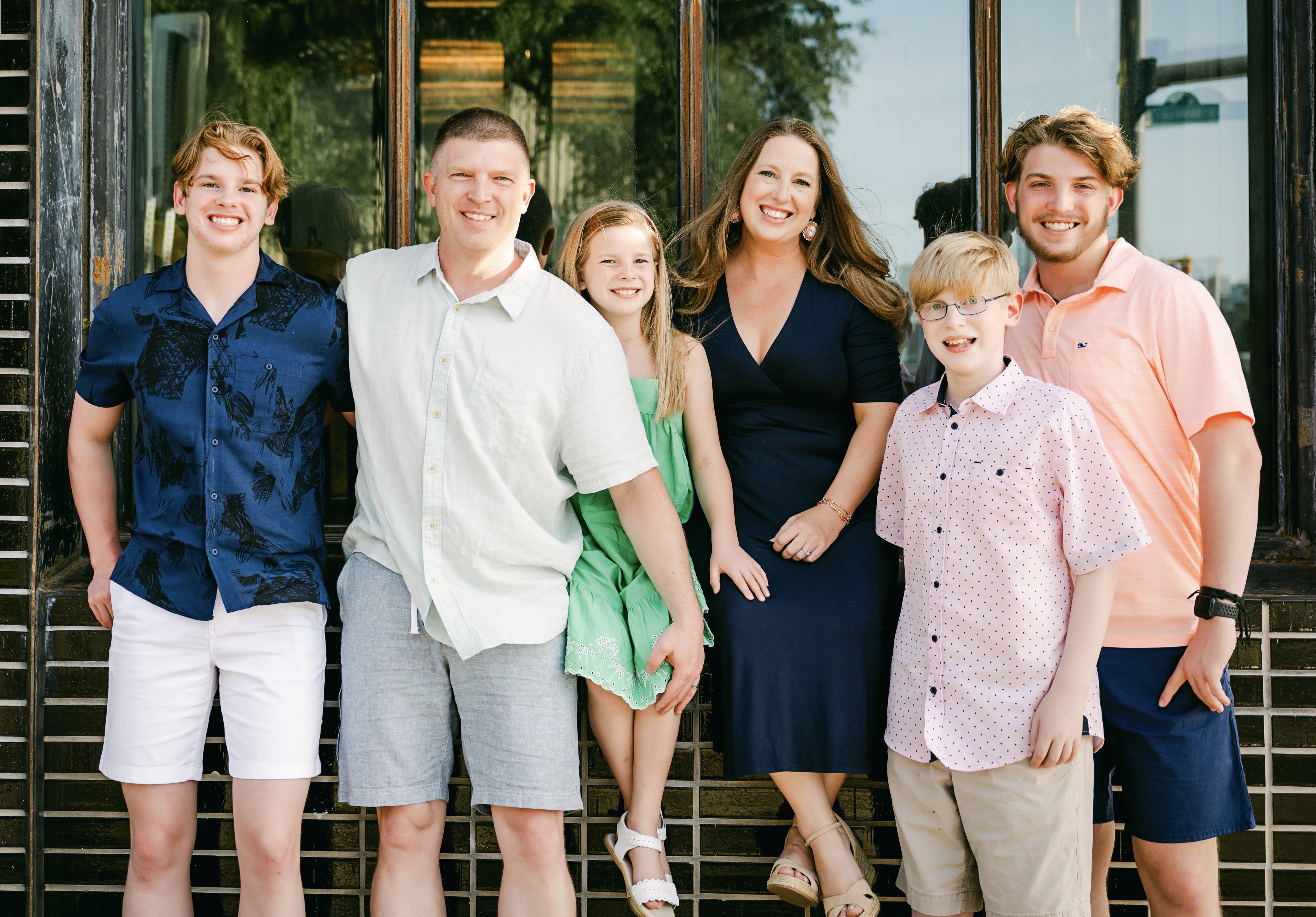 A family of six, smiling at the camera